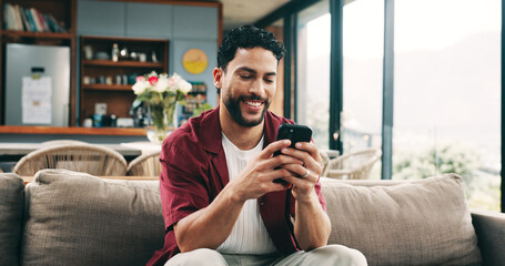 Smile, man and relax with phone at house for social media, browsing website and texting contact....