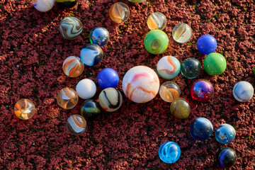 marbles of all colors and a spinning top