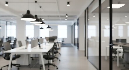 Modern open-plan office environment with sleek white desks, ergonomic black chairs, and contemporary lighting fixtures.
