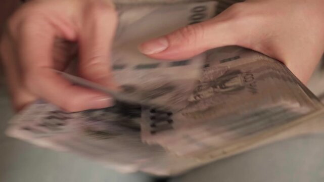 Kyrgyzstan som money holding. Woman hands counting a stack of banknotes. Kyrgyz KGS paper cash. Concept of income, success, business, tax, economy and finance