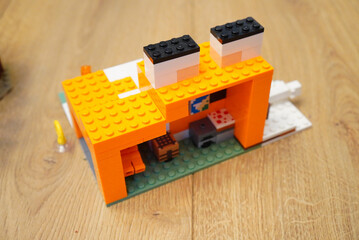 Obraz premium Lego Minecraft Fox House Build on Wooden Surface, Creative Toy Concept