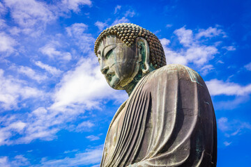 Daibutsu or Great Buddha of Kamakura in Kotokuin Temple with blue sky background at Kanagawa...