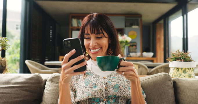 Woman, relax and coffee with phone at house for social media, browsing website and texting contact. Smile, mature person and mobile with herbal drink, online notification and chat with message update - Powered by Adobe