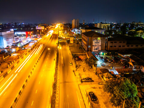 Aerial view of the GRA Junction where vibrant streaks of headlights paint the Aba Road at night, Port Harcourt, Rivers State, Nigeria.