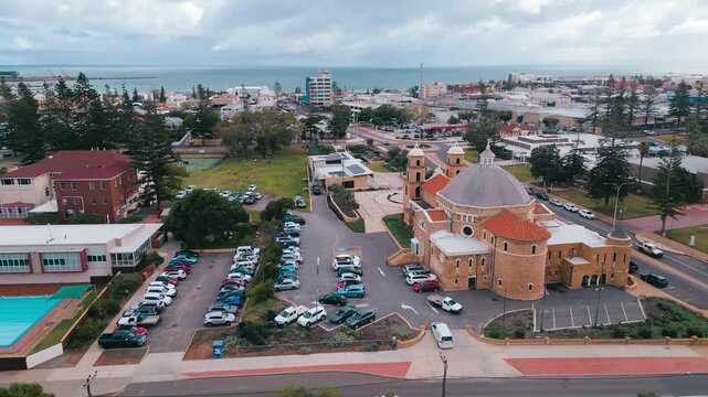 Cinematic aerial footage panning away and upwards from St Francis Xavier Cathedral to reveal the surroundings of the beautiful cathedral in Geraldton, Perth, Western Australia.