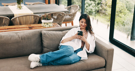 Smile, woman and relax with phone at house for social media, browsing website and texting contact. Person, resting and mobile to download game, online notification and chat for message update on sofa