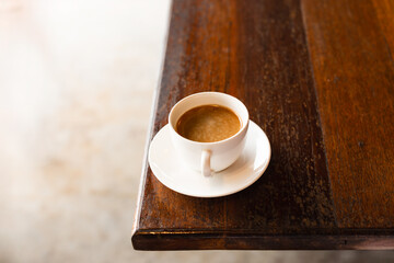 A cup of coffee on wooden table.