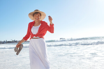 Portrait, mature woman and smile on beach for travel, adventure and summer holiday. Space, female person and walking in ocean water for tourism fun, explore nature and tropical vacation for getaway
