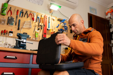 Man opening toolbox preparing for home workshop repair