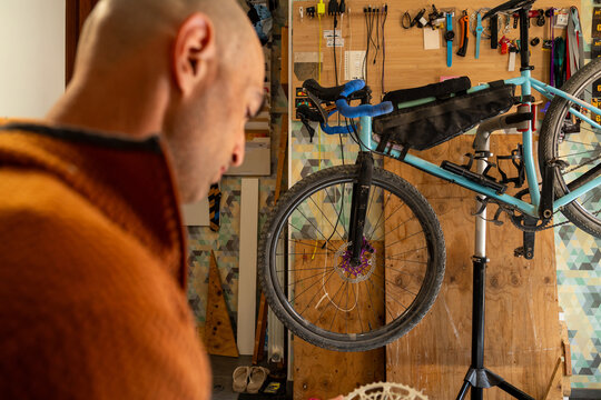 Cyclist performing bike repair and maintenance at home