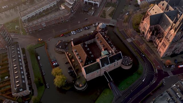 Aerial view of Kasteel Woerden and Sint-Bonaventurakerk, with contrasting architecture and colors surrounded by roads and water, Woerden, Utrecht, Netherlands.