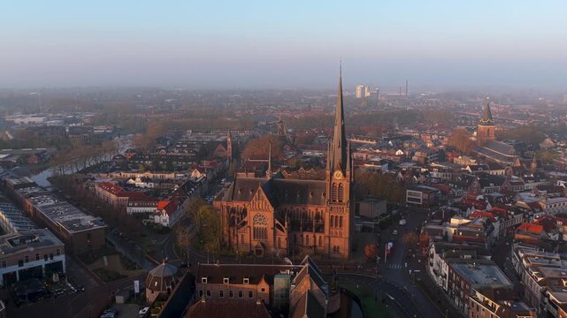 Aerial view of Sint-Bonaventurakerk, Kasteel Woerden, and surrounding buildings in a dense urban landscape, Woerden, Utrecht, Netherlands.