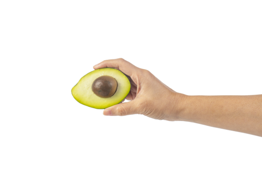 whole and half avocado and hand isolated on transparent background close-up.