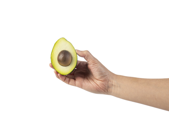 whole and half avocado and hand isolated on transparent background close-up.