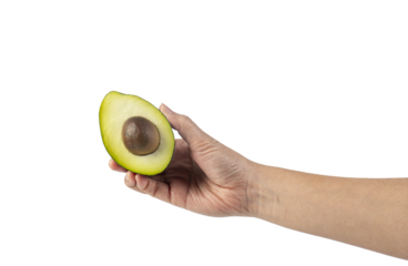 whole and half avocado and hand isolated on transparent background close-up.