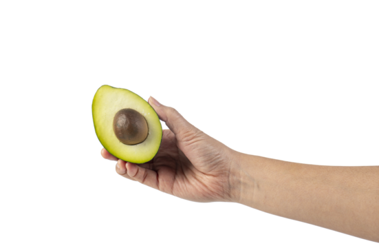 whole and half avocado and hand isolated on transparent background close-up.