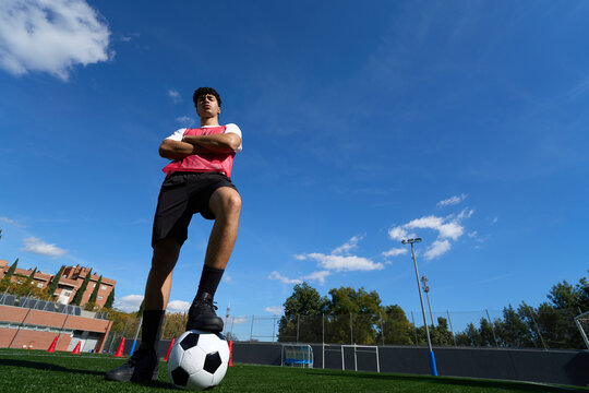 Confident young soccer player having a break