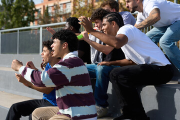 Diverse men spectators cheering exciting sport event outdoors