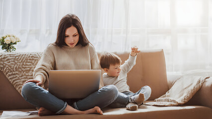 Woman Working on Laptop at Home with Her Son