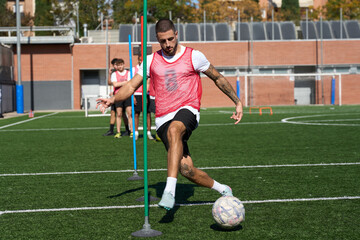 Soccer player dribbling ball during training drill