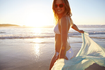 Travel, bikini and sunset with woman at beach for summer vacation, peace and tropical destination. Tourism, relax and weekend break with person outdoor for space, coastal paradise and holiday trip