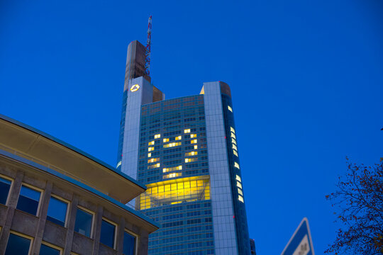 Looking up Commerzbank / Dresdner Bank silver tower with heart shape window lights on an autumn evening. Photo taken November 22nd, 2025, Frankfurt am Main, Germany.