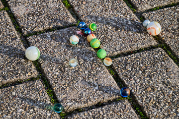 Outdoor. Colored marbles on a paved floor