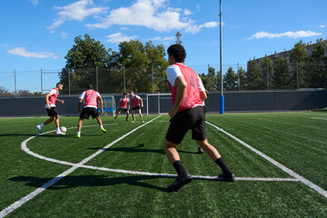 Men training soccer on a football pitch