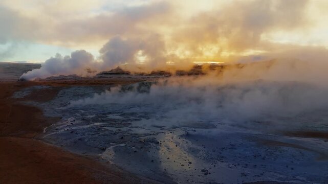 Drone shot over Iceland&rsquo;s Hverir geothermal fields, revealing dramatic steam vents, colorful sulfur textures, and raw volcanic energy in a surreal otherworldly landscape.
