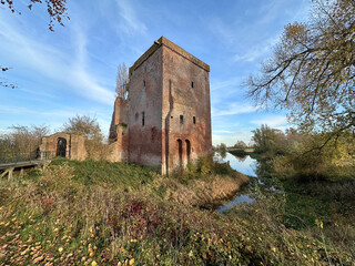 Ruins of Slot Nijenbeek castle reflected in the autumn landscape near the IJssel river © Henk Blijderveen van