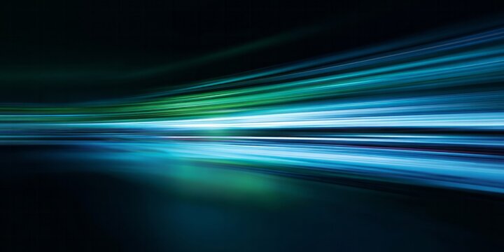 Intense motion blur streaks across a dark background with vibrant blue and green light trails