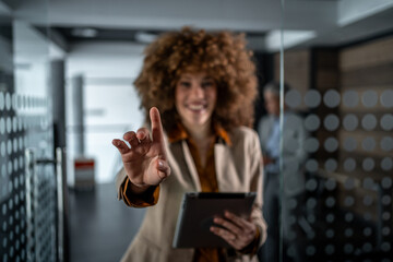 Businesswoman touching virtual interface screen in modern office