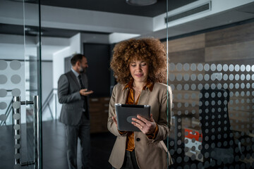 Professional businesswoman using digital tablet in modern office