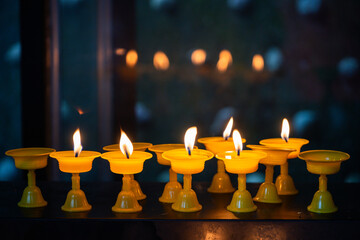 Vibrant yellow candles illuminate a serene atmosphere
