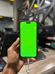 Screen in Modern Office Workspace with Laptops, Charging Cable, Wooden Desk, and Blurred Background Showing Professional Work Environment for Technology