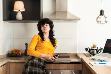 Confident latina posing with relaxed attitude in modern interior