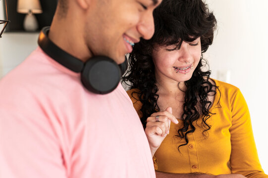 Latino friends enjoying relaxed digital interaction in modern lifestyle