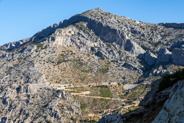 Mountains jutting out onto the Adriatic coast in Makarska, Croatia. Drone shot.