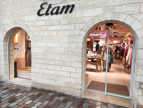 Paris, France - November 22, 2025: Etam clothing store entrance showcasing stylish apparel and inviting atmosphere with vibrant displays and warm lighting, perfect for fashion enthusiasts