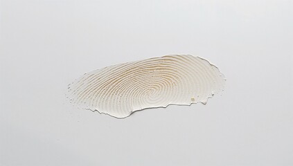Showing thin beige fingerprint impression with central whorl on gray tabletop, with droplets