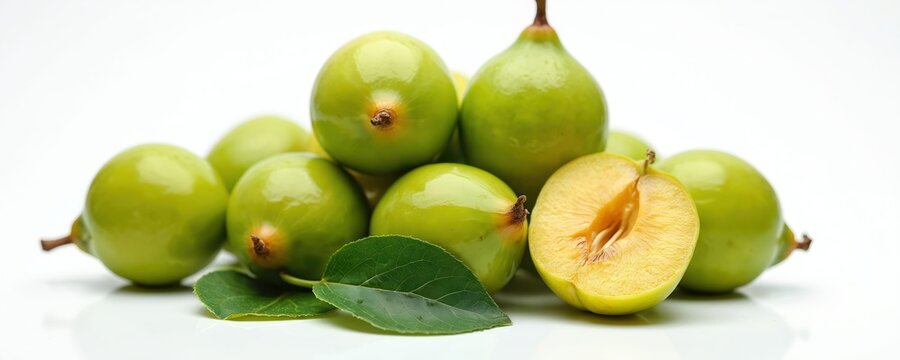 Kakadu plum fruits heap isolated on white background. Whole green gubinge with leaves, cut half. Australian superfood berry rich in vitamin C for natural skincare ingredient, healthy diet, raw food,