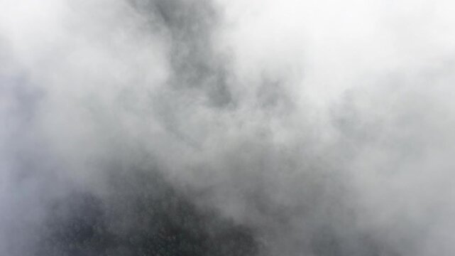 Aerial view of a stunning cloudscape showing shades of grey and white, creating a dramatic contrast between the dark and light areas, Orschwiller, Grand Est, France.