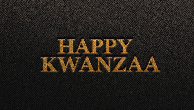 Showing centered gold embossed HAPPY KWANZAA on dark leather surface, casting metallic highlights