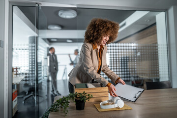Woman unpacking office supplies starting new job