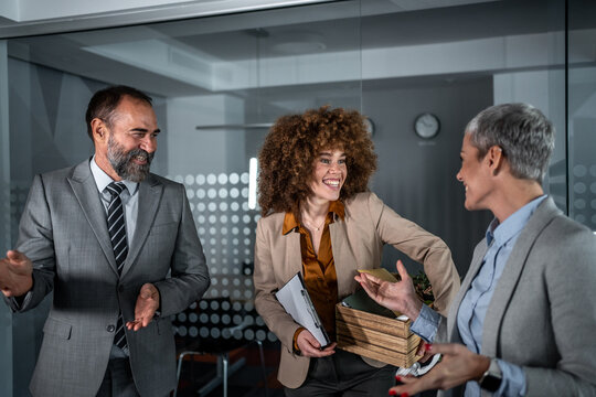 Business colleagues welcoming new diverse team member to office