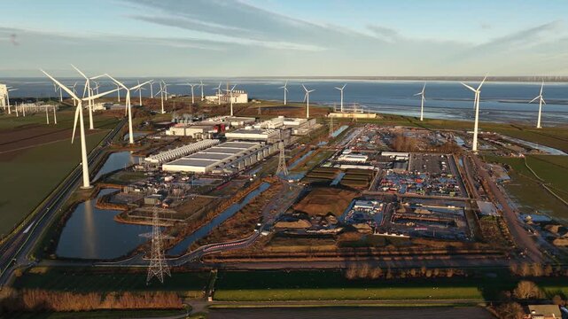 Aerial drone view of a major data center expansion (new build) next to an existing hyperscaler facility in Eemshaven, Netherlands. Highlights global cloud infrastructure growth.