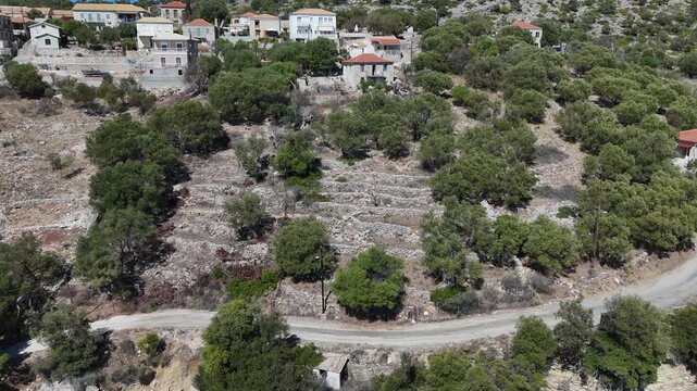 Kastos Island,Aerial view backwards from the houses on the hill towards the sun soaked harbor.Beautiful sunny day.Crystal clear waters,