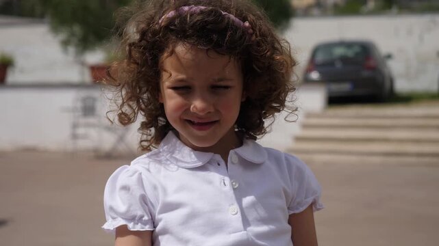 Little girl looking at camera with puzzled expression