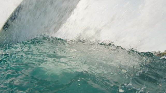 Surfer rides the ocean wave in the Maldives and does radical snap on the section