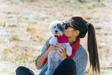 Woman Hugging her Havanese Dog with Red Scarf .Fashion for Owner and Dog 